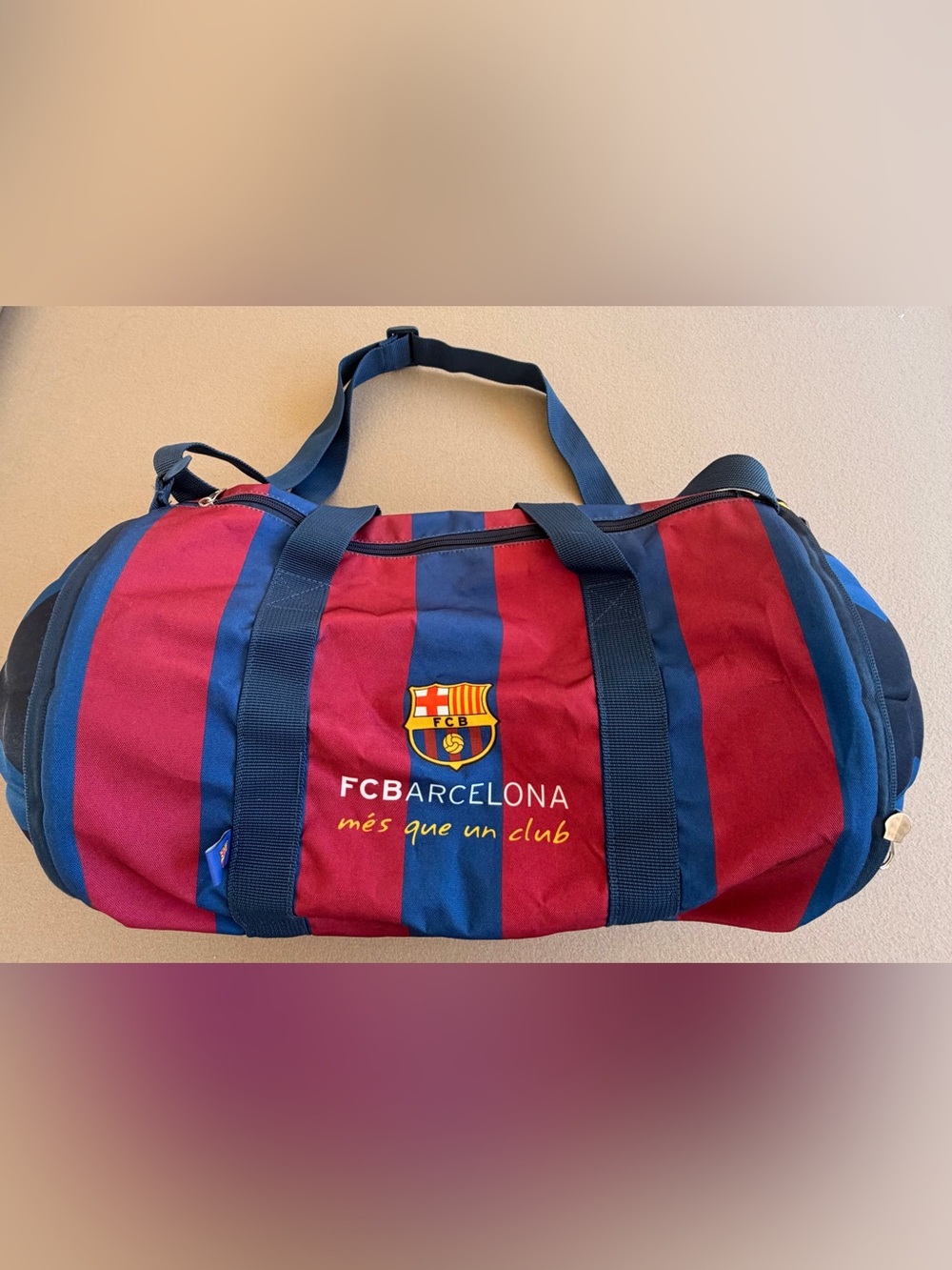 FC Barcelona Striped Duffel Bag in Maroon and Blue. Zips into a soccer ball.